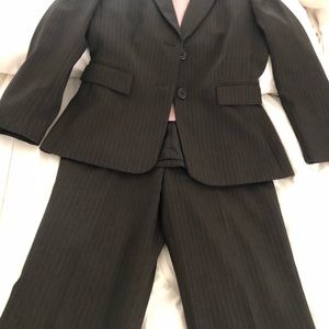 Tahari grey pin stripped 2 piece suit. Hardly wrinkles. Very clean and fresh.